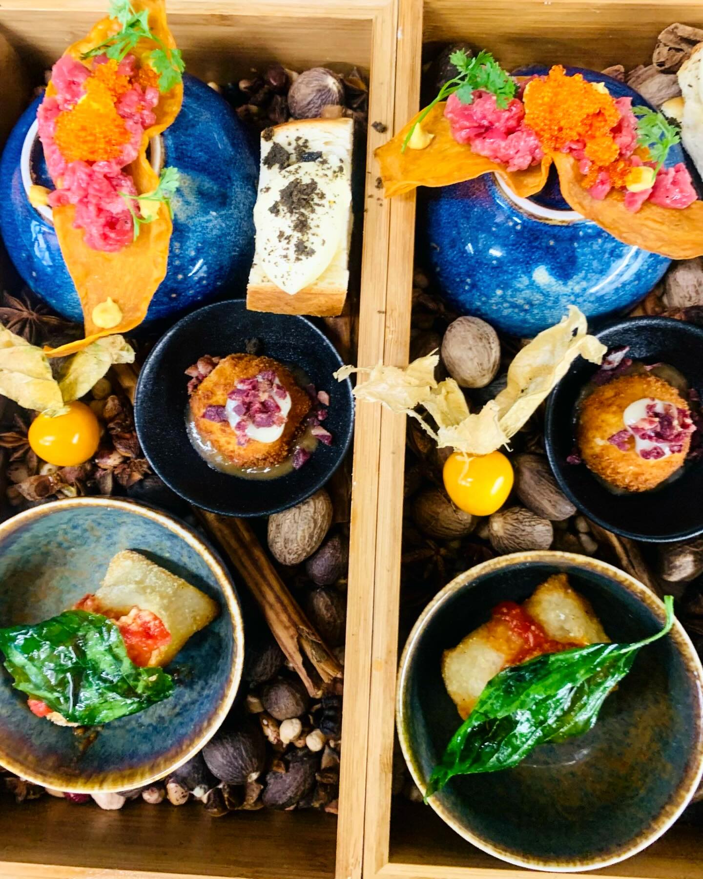Assorted small plates arranged in a wooden service tray.